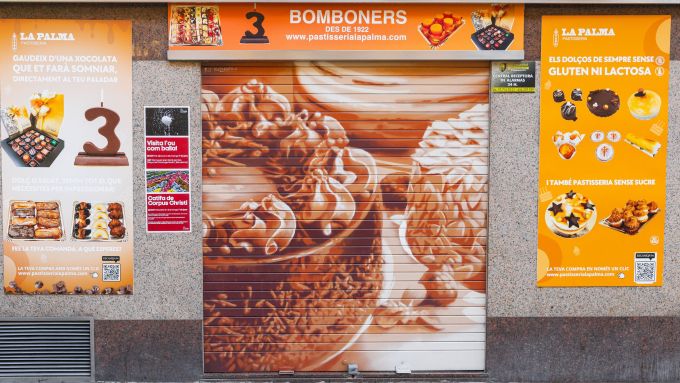 Roc Blackblock y su obra plasmada en uno de los comercios más emblemáticos del Clot, La Palma. Foto: Rebobinart.